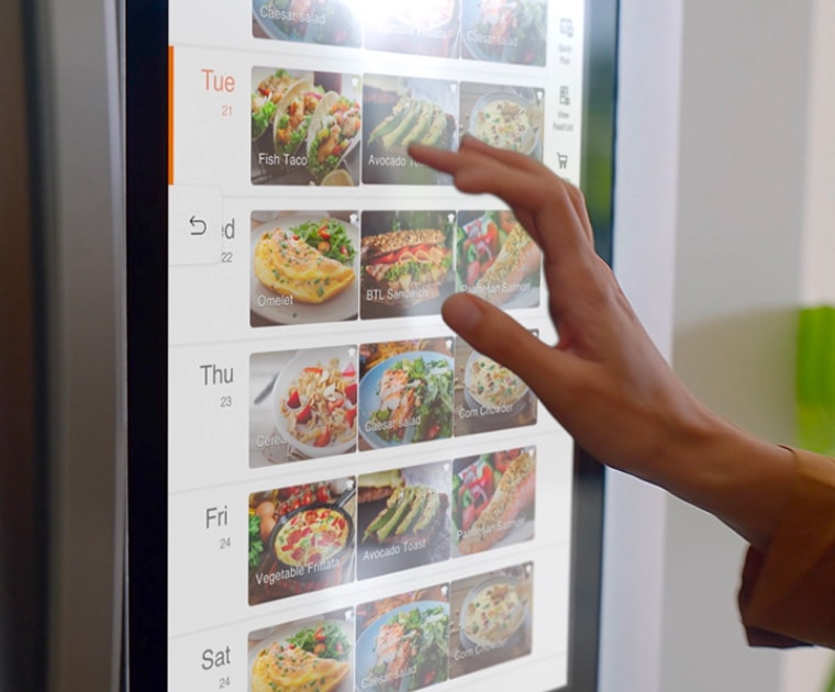 hand using a smart connected refrigerator